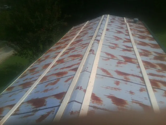 Rusted metal roof panels with new wood purlins before replacement — Storm Damage Roof Repair in Hammond by Roofing Brothers